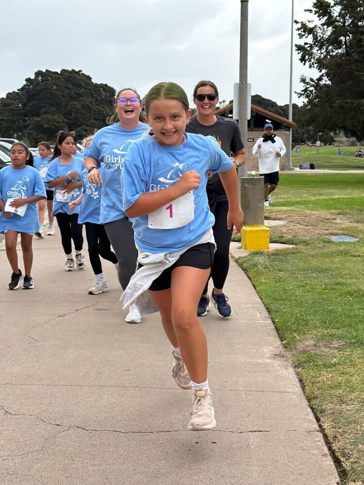 Students, families, and staff participate in the Girls on the Run 5K.