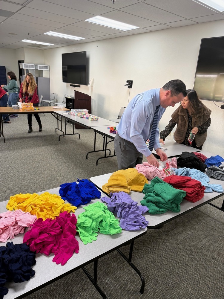 Staff assemble gift bags for students.