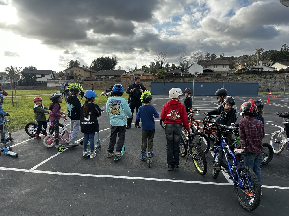 children on their backs with a police officer