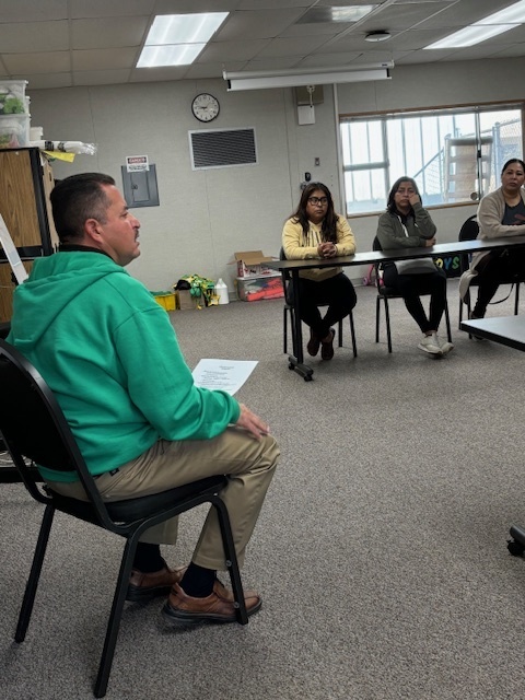 Principal Lopez is sitting and speaking to parets at Cofee with the Principal