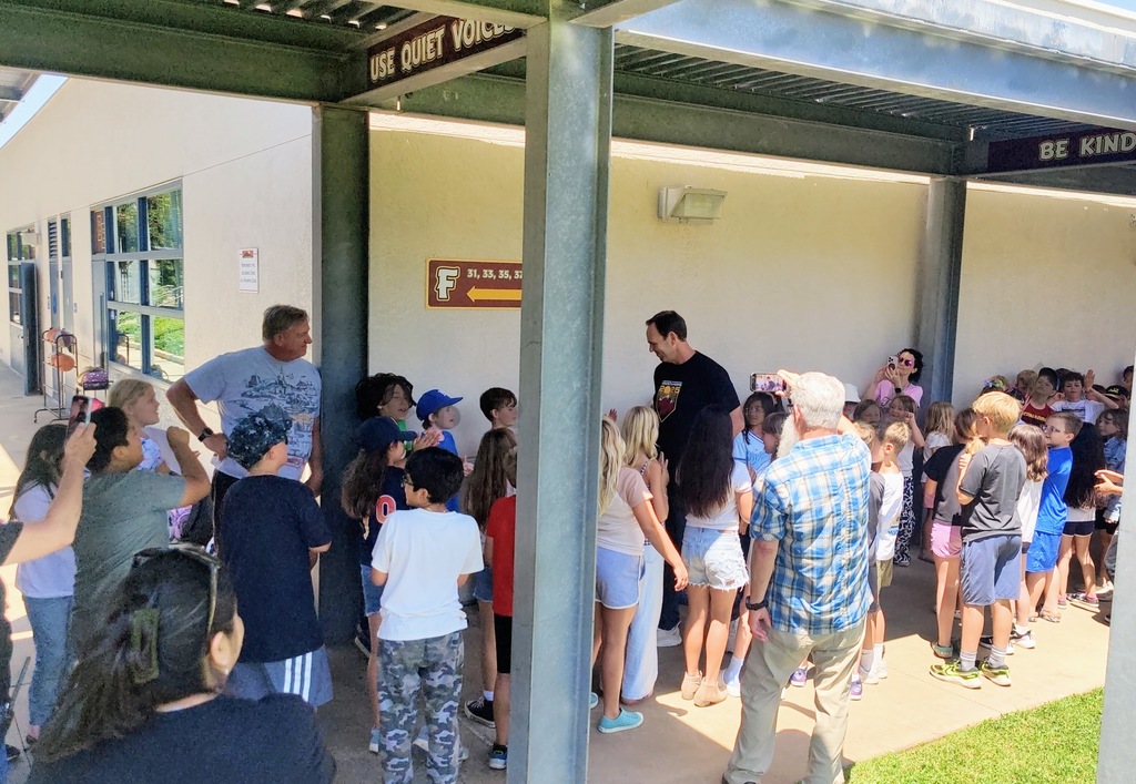 Mr. Lyche being clapped out by 4th grade students down the hallway
