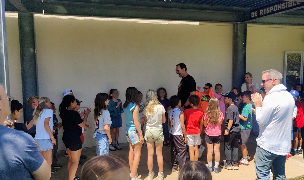 Mr. Lyche being clapped out by 3rd grade students down the hallway