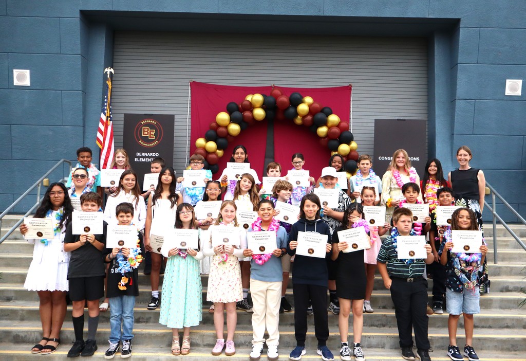 Mrs. Powers on stage with her promoted 5th grade students