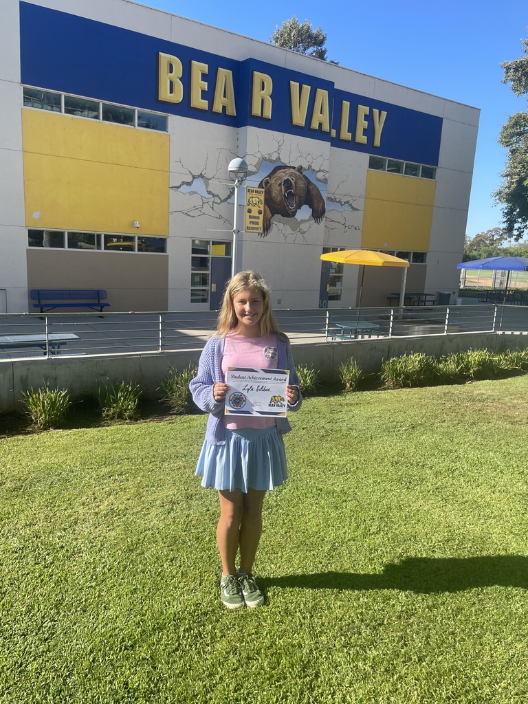 Picture of student holding award