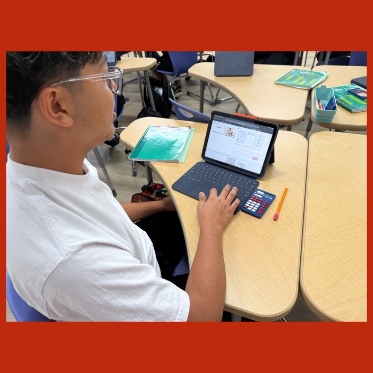 A photo of a student in action as he scales one of the recipes in the "Recipe Challenge"