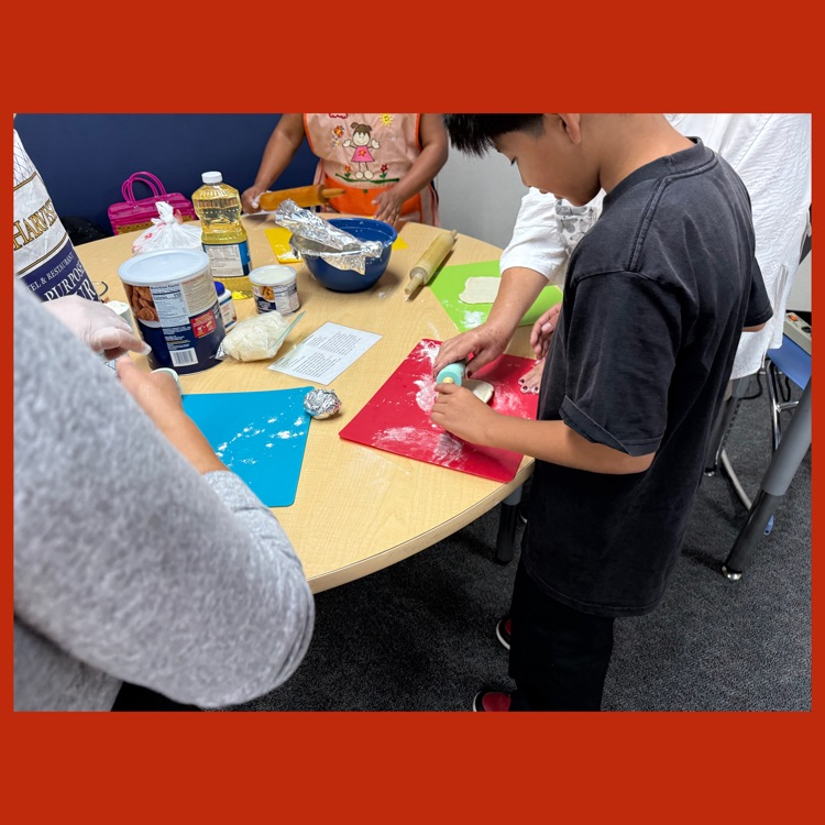 A photo of a student helping our Wildcat parents prepare tortillas