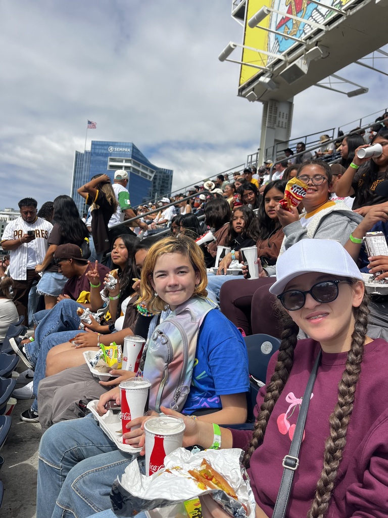 XTrack students enjoying their meal and snacks and the game at the stadium stands.