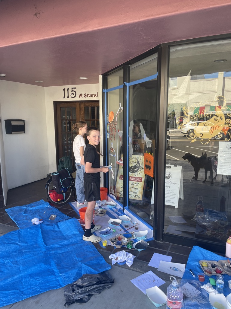 Students painting on window