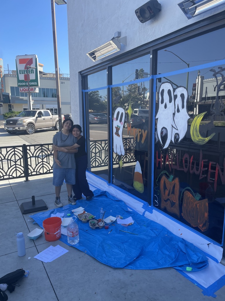 Students painting on window
