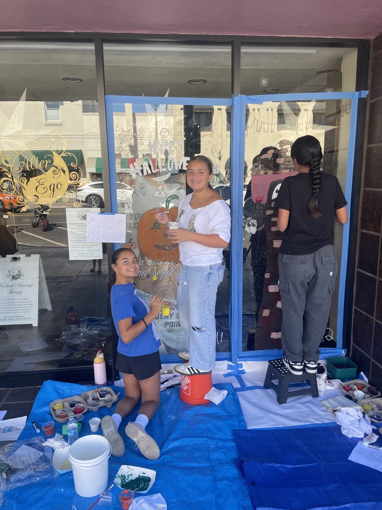 Students painting on window