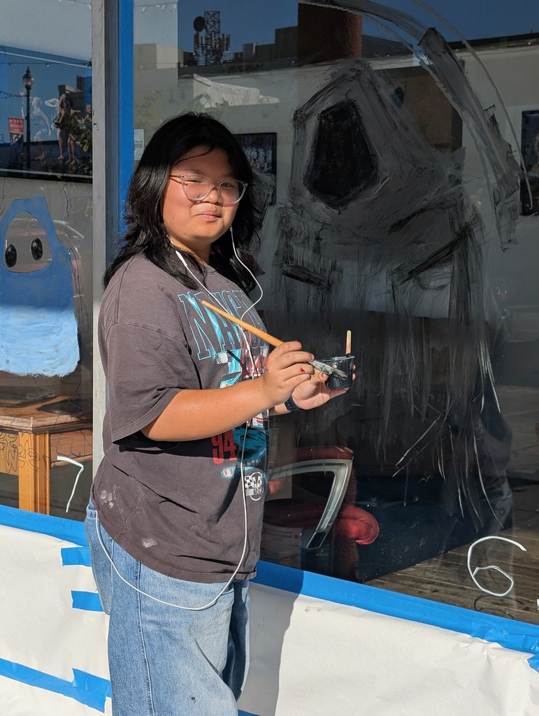 Sophia Ranion working on her grim painting Halloween painting.