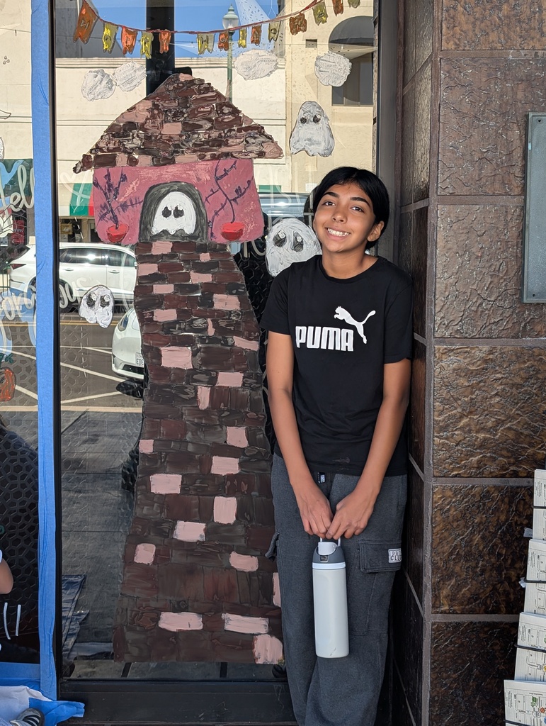 Aubrey Hernandez with her Tower Halloween window painting.