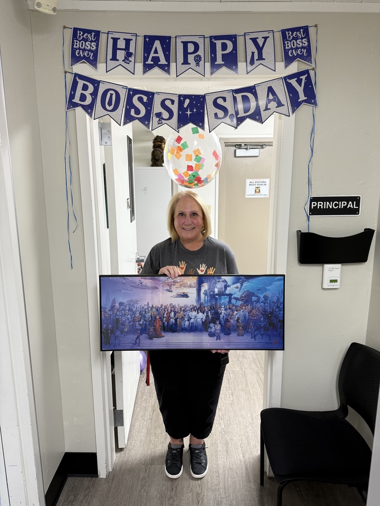 Principal holding a framed Star Wars photo