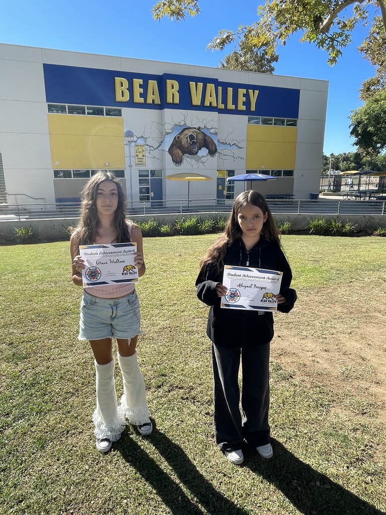 Picture of two students holding awards