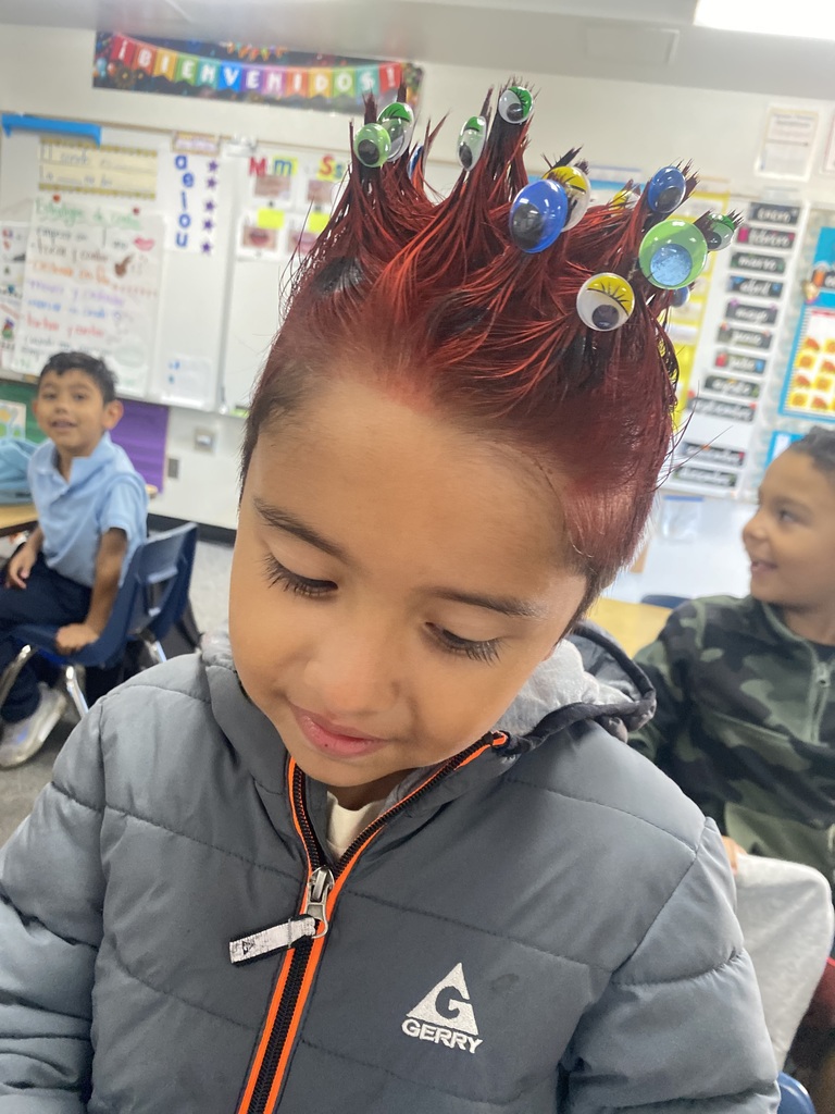 student with red hair and googly eyes