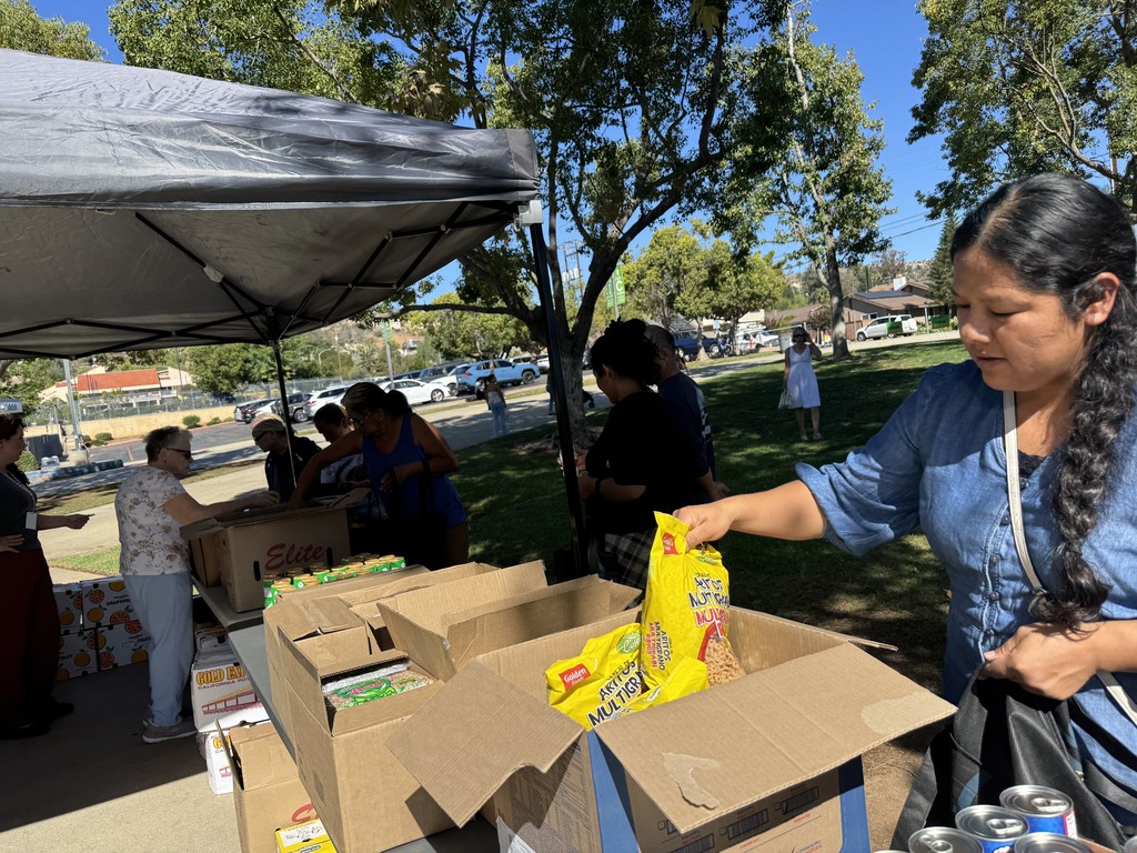 Picture of families getting food pantry items at Conway Academy