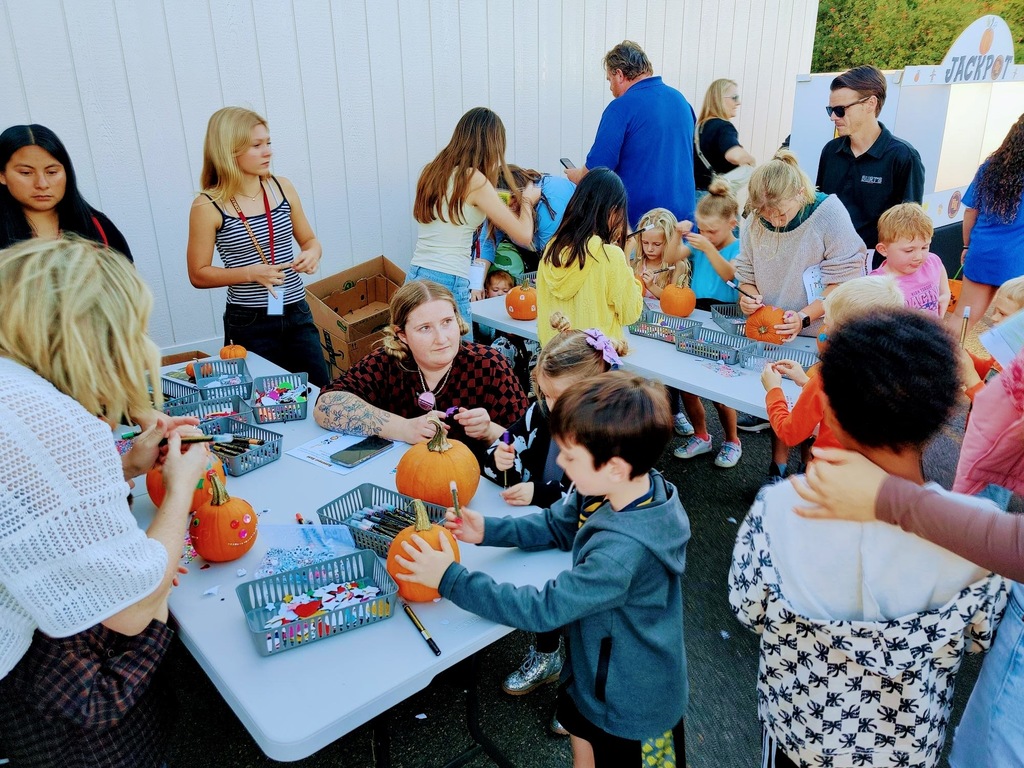 Fall Fest students painting pumpkins