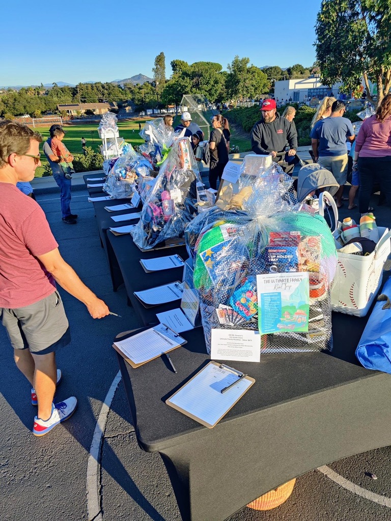 Fall Fest parents bidding at the Basket Silent Auction