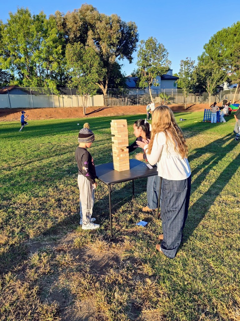 Fall Fest students playing jenga on the field