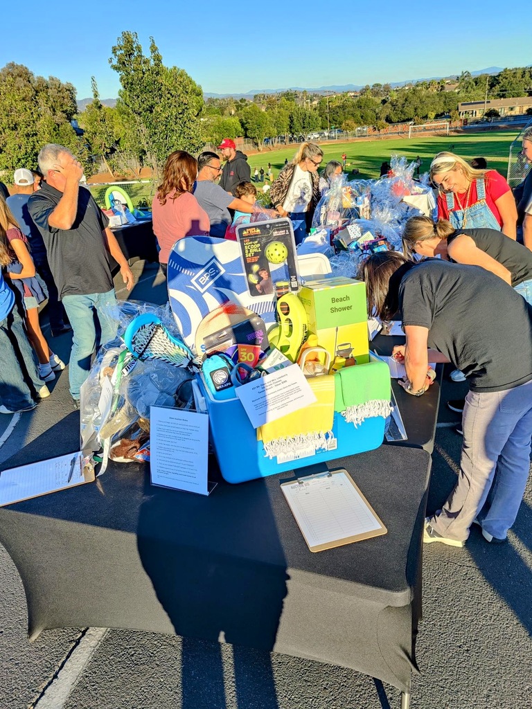 Fall Fest parents bidding at the Basket Silent Auction
