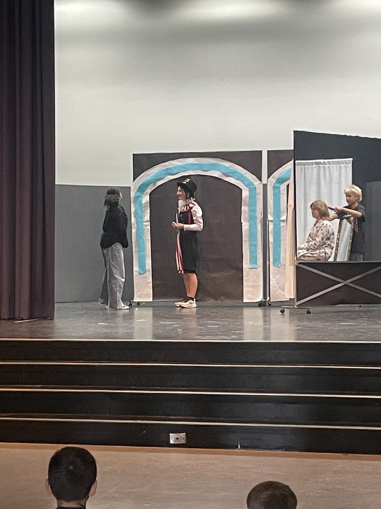 Students acting on stage