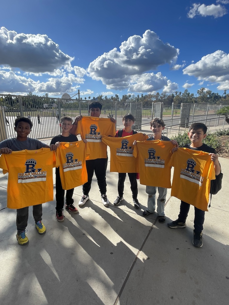 Picture of students holding their championship t-shirts