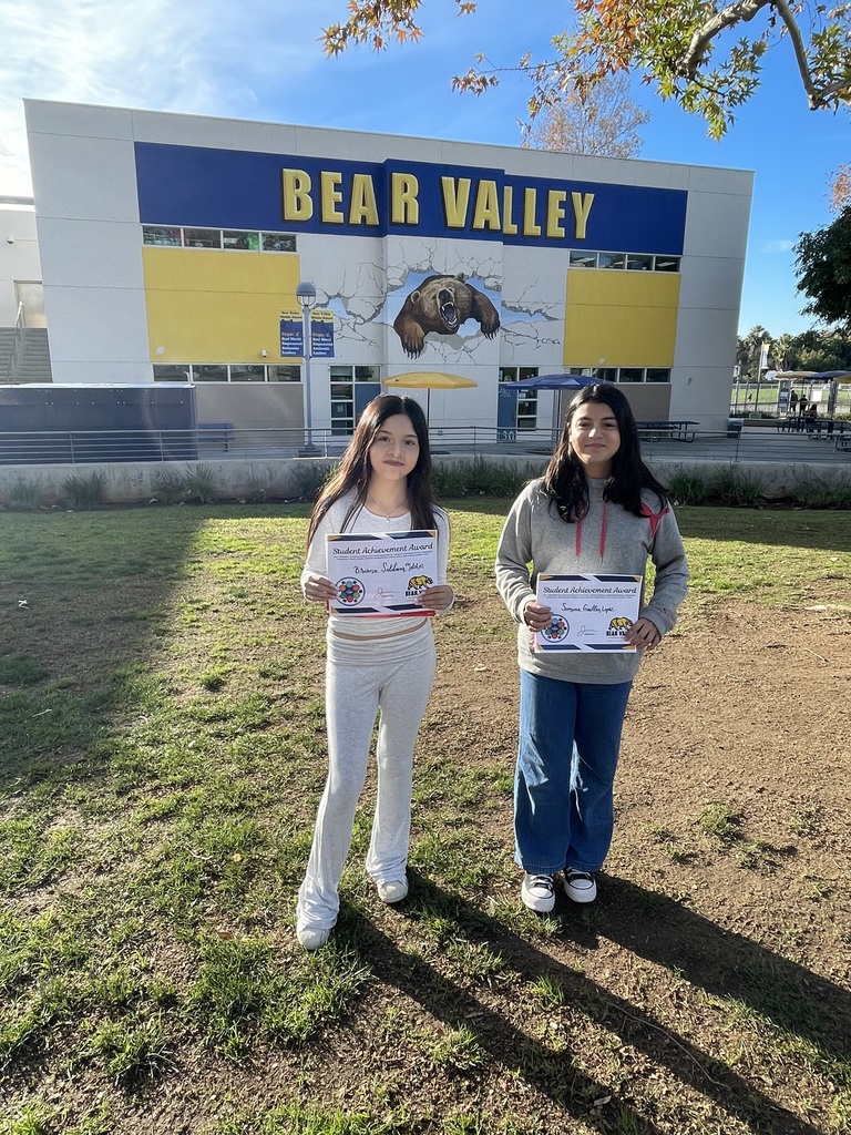 Picture of two students holding awards