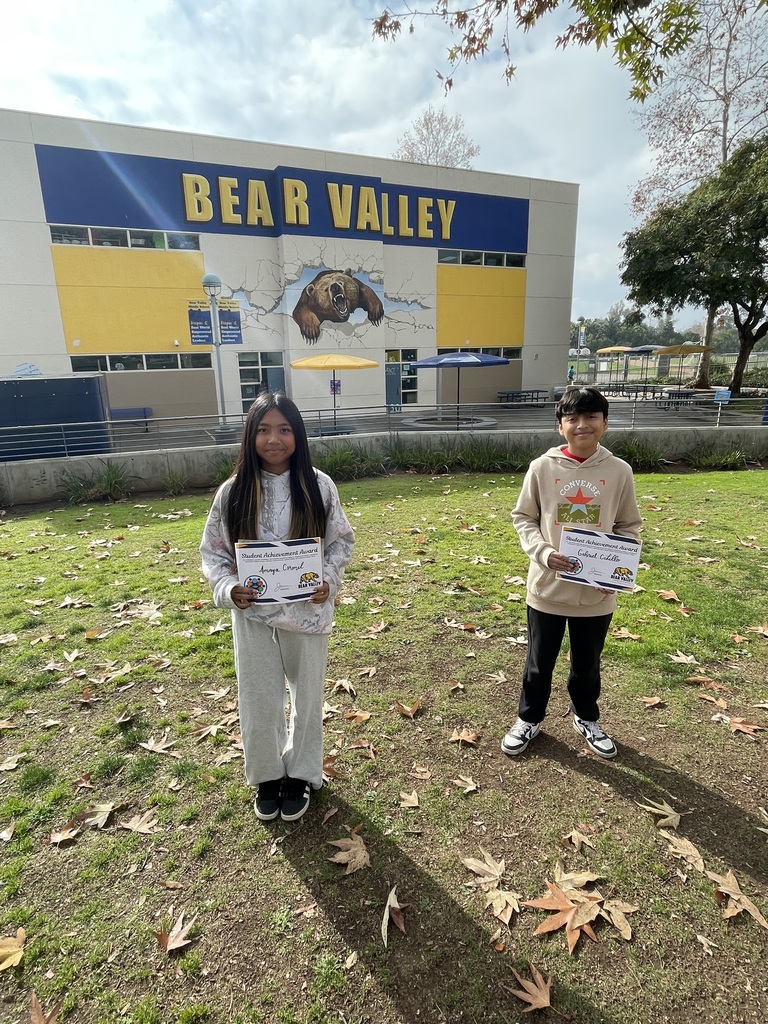 Picture of two students holding awards