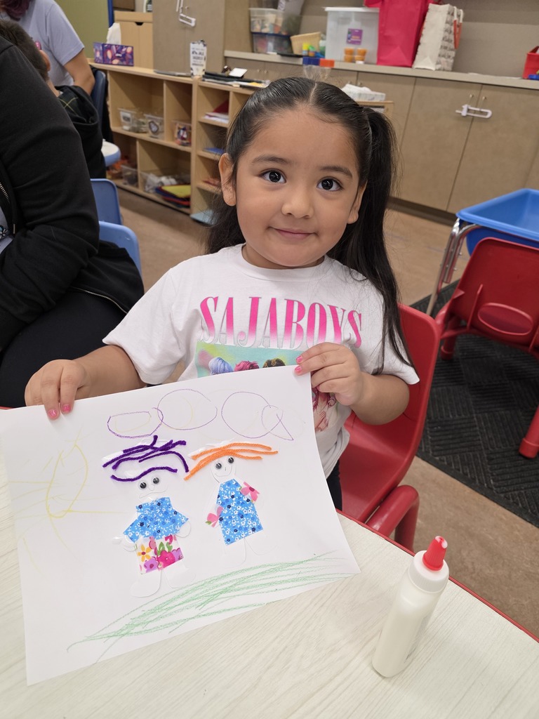 Child holding art work 