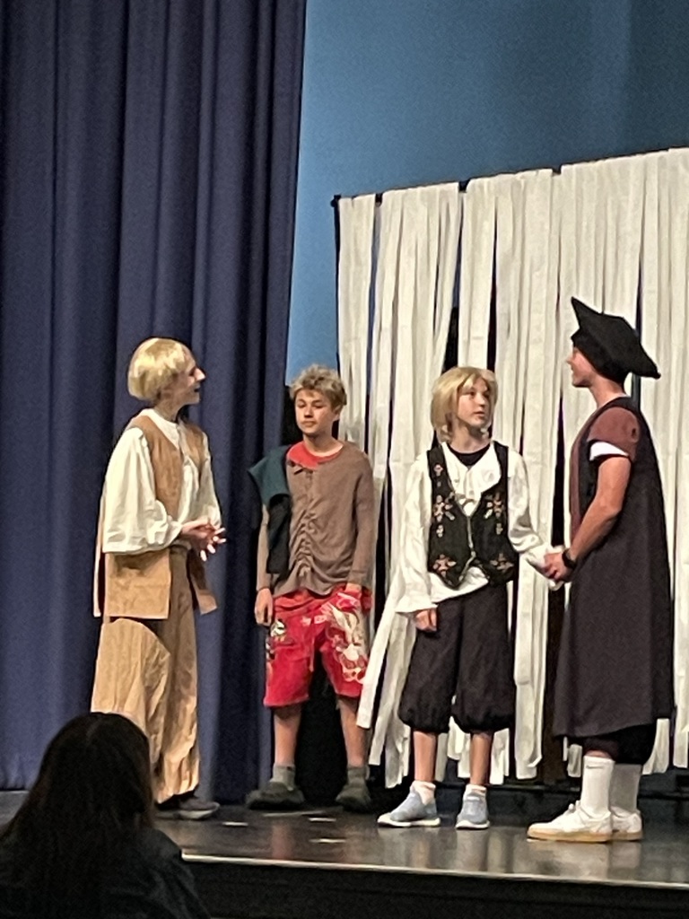 Students on stage performing a play