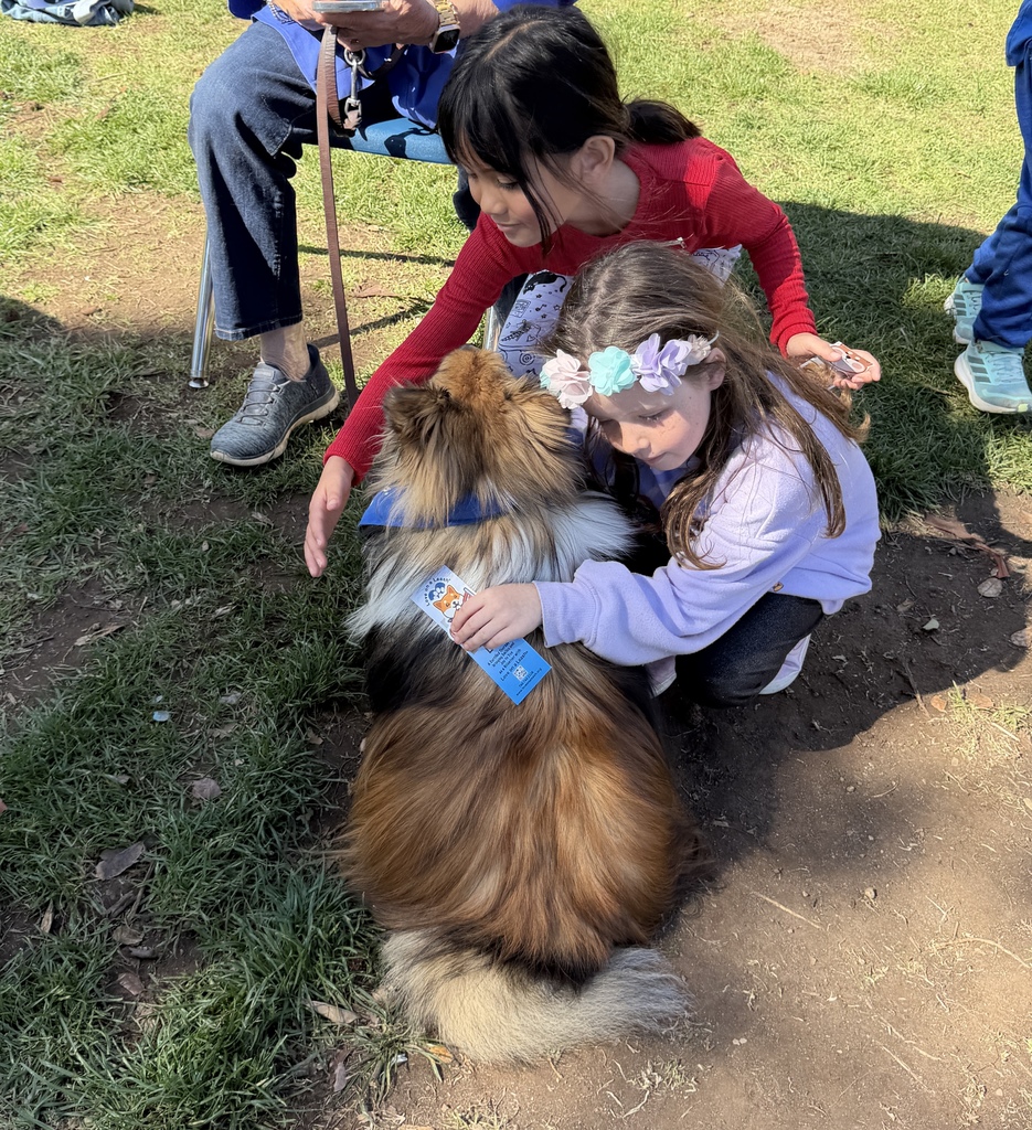two girls petting a dog