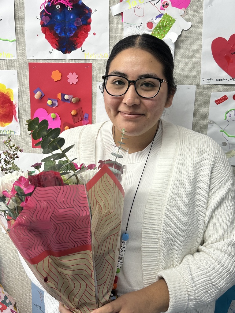 Ms. Rebeca holding flowers