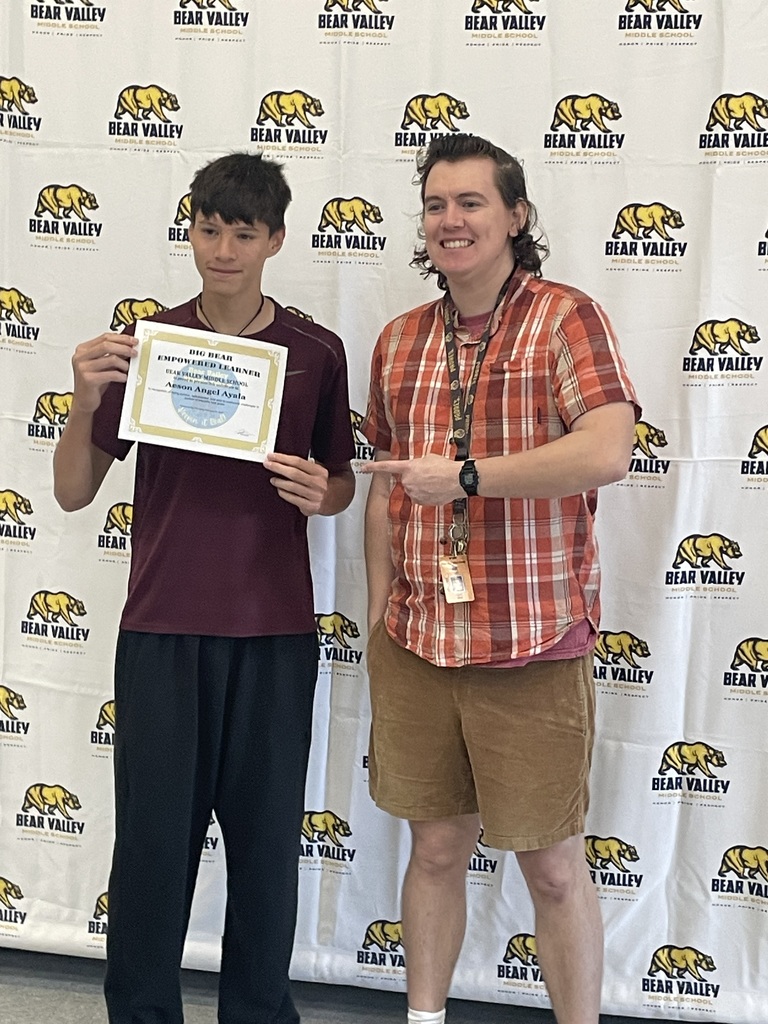 teacher and student with award