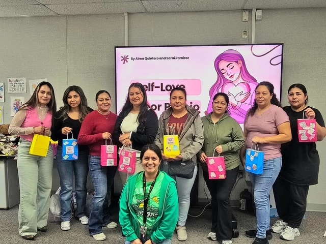 Eight moms and the family liaison pose for a picture after having created their self care goodie bags. 