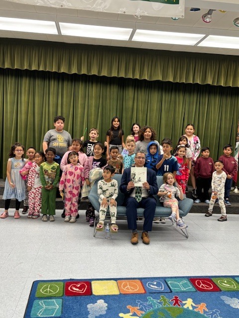 23 students pose for a picture with Dr. Ibarra inside the multipurpose room. 