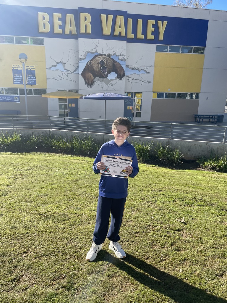 Student holding award