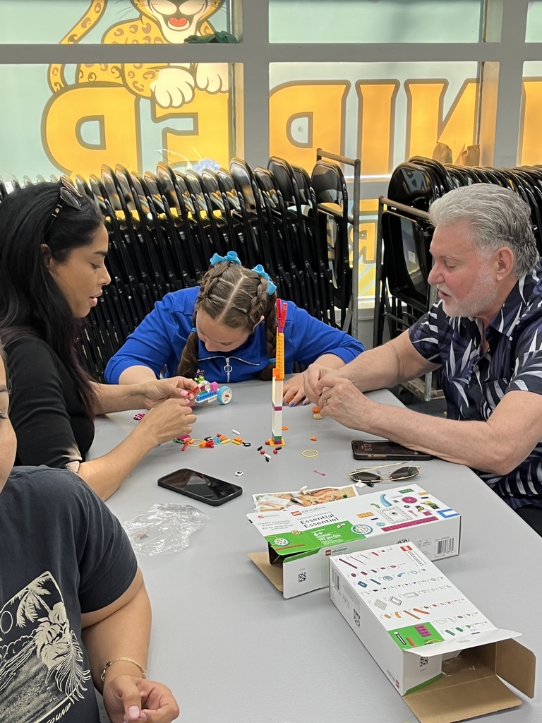 Parents and students working with Legos