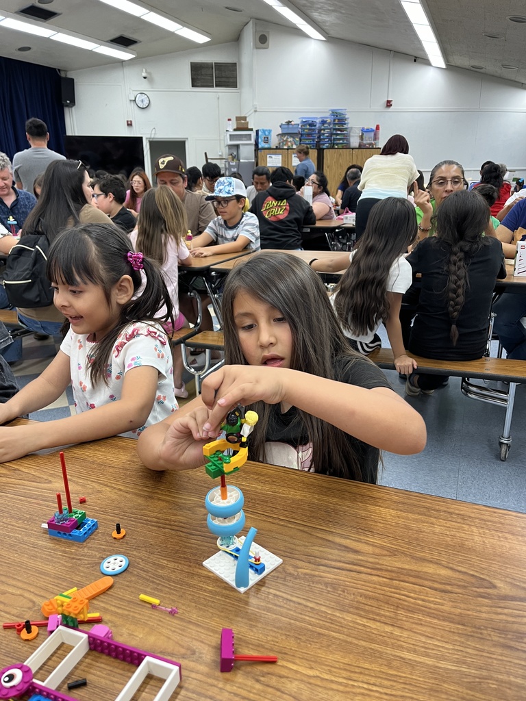 Parents and students working with Legos