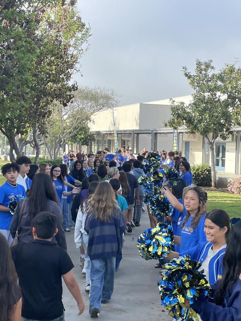 Students walking through students cheering