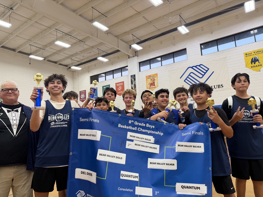 students celebrating championship and holding trophies