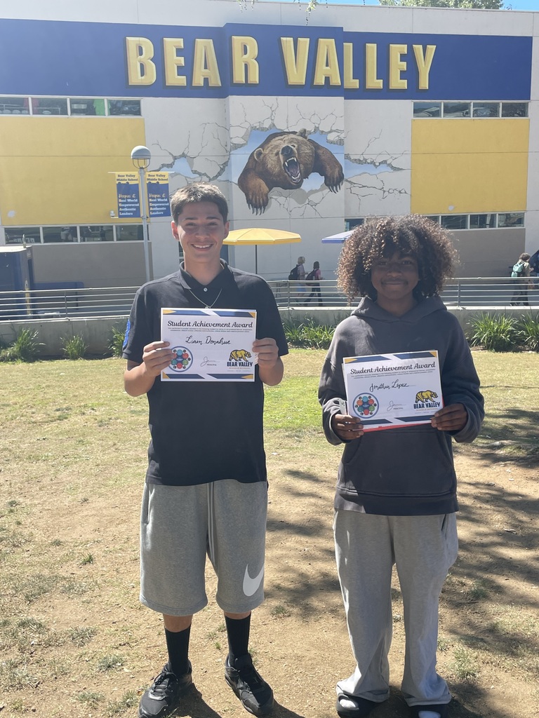 two students holding award