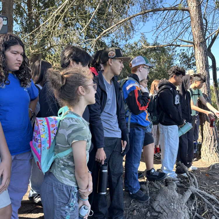 students releasing trout at Miramar lake.