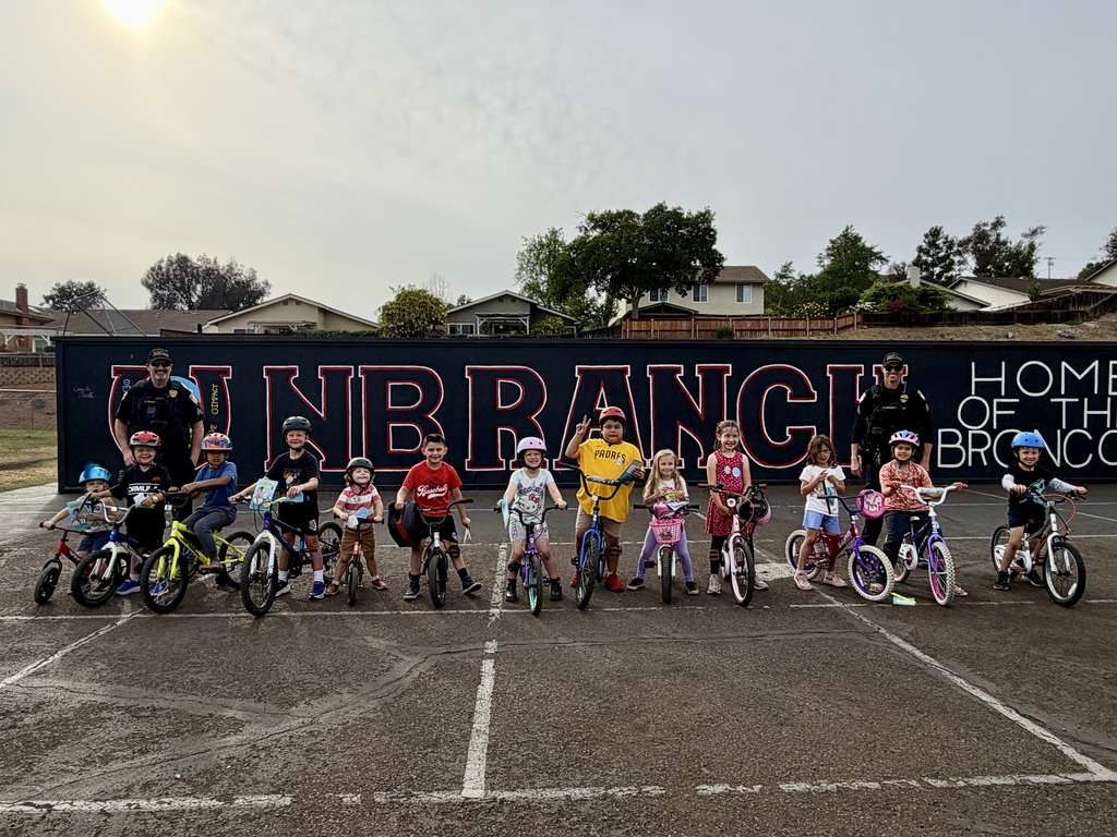 Students on their bikes with 2 police officers