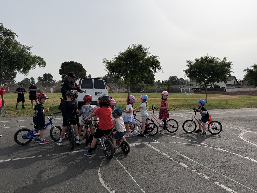 Students on their bikes with a police officer