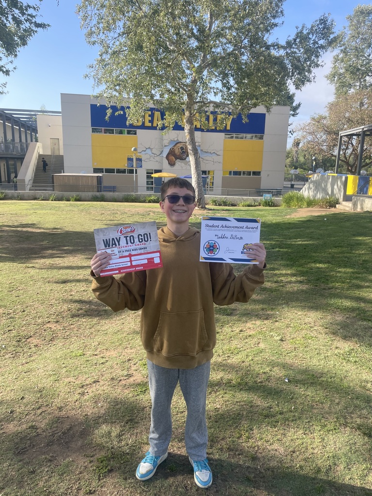 student holding awards