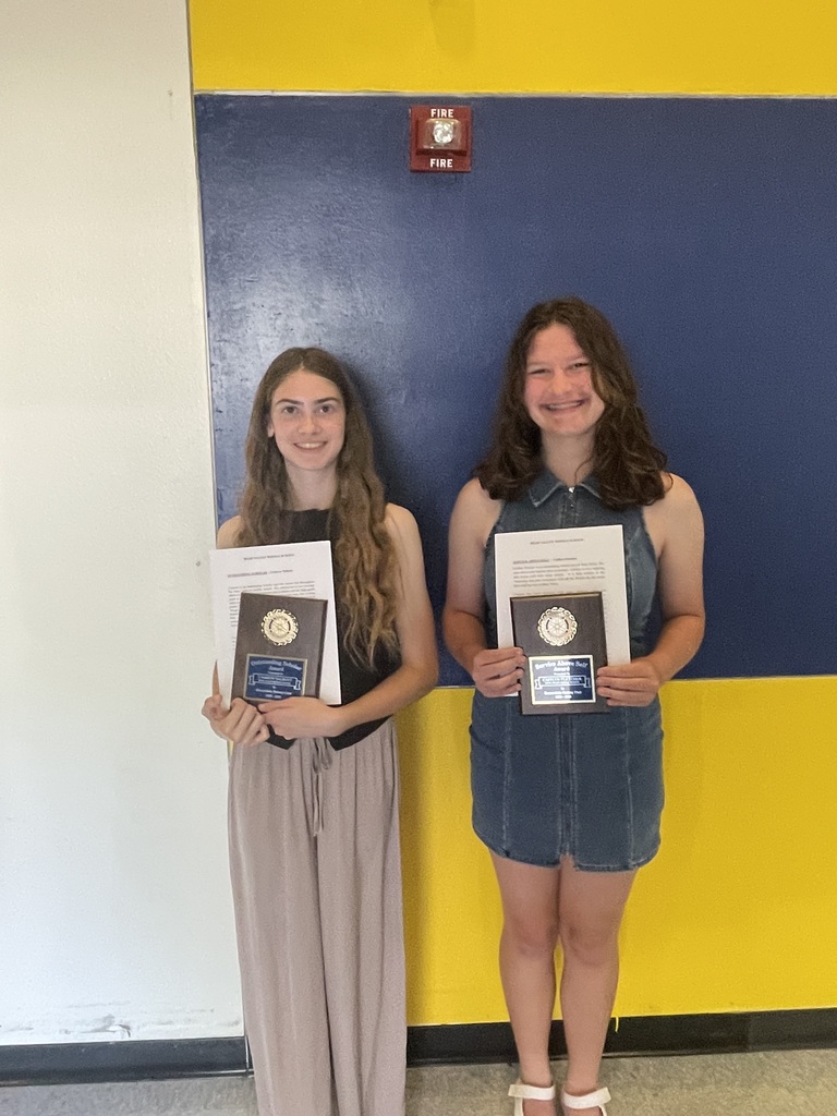 Two students holding rotary awards