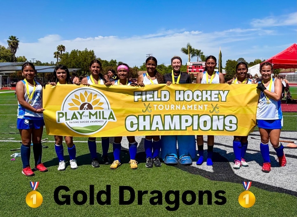Gold Dragon Champion Team holding a Play for Mila Field Hockey Tournament Sign 
