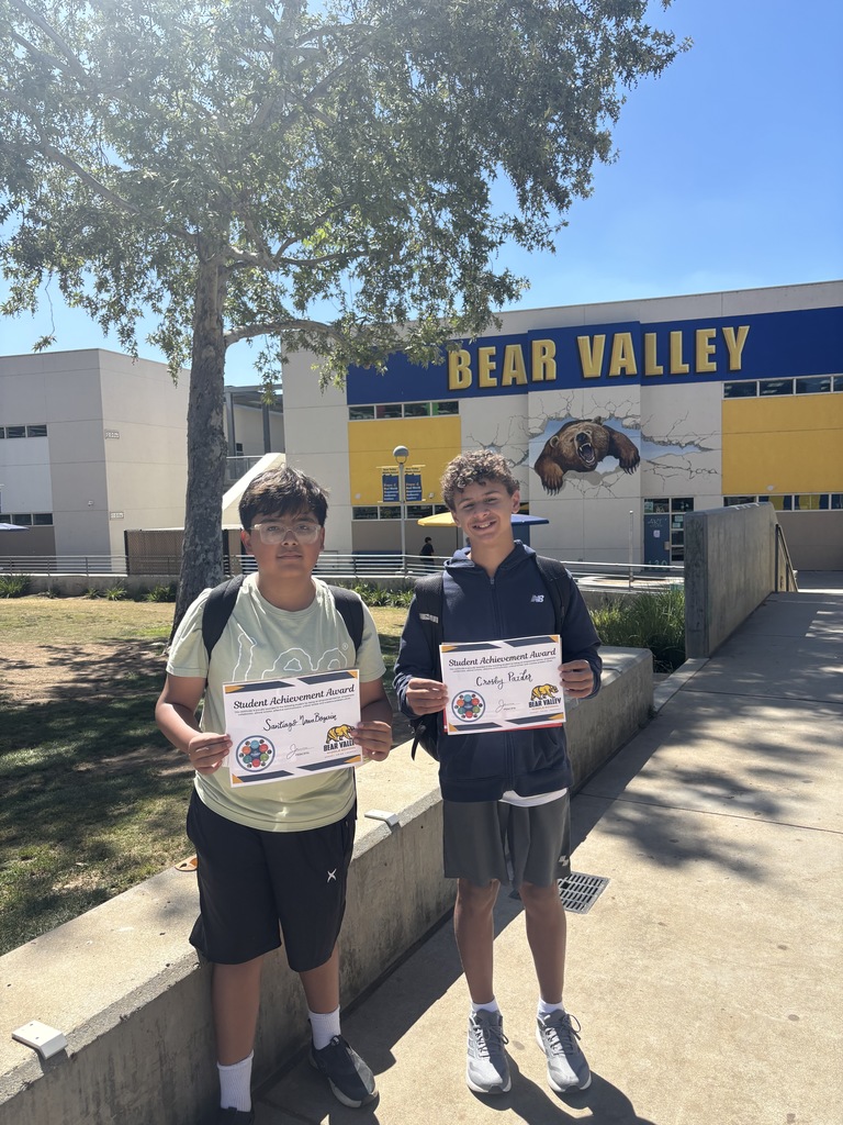 Two students holding awards