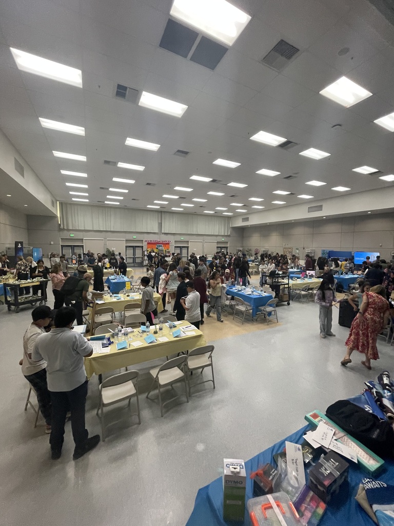 Students rotating tables at scientist event