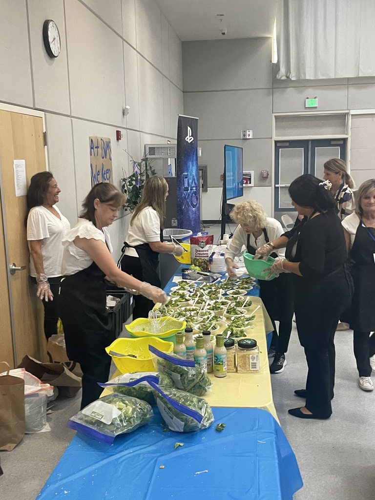 Parent volunteers making salads